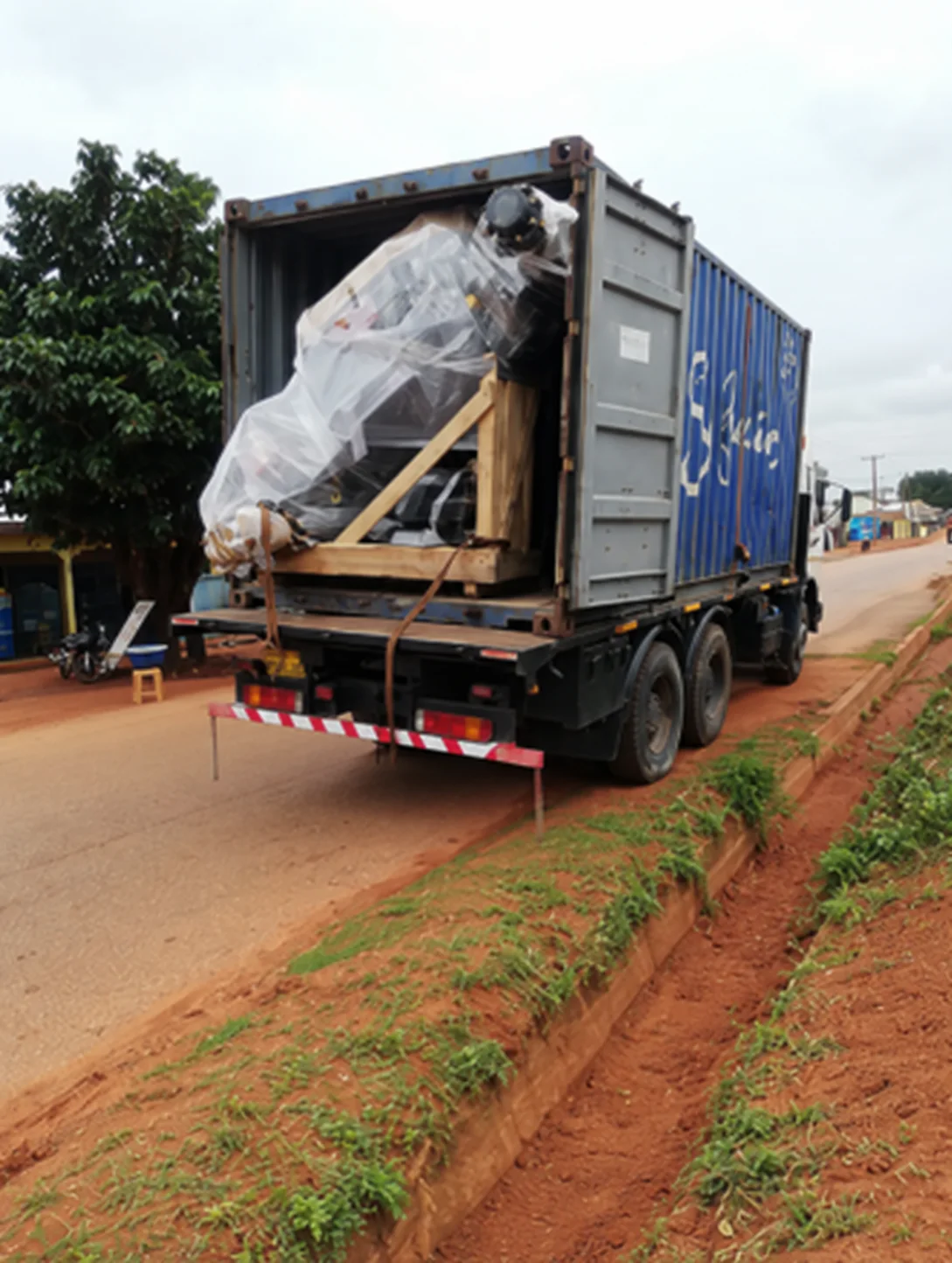 Open shipping container with agricultural equipment inside