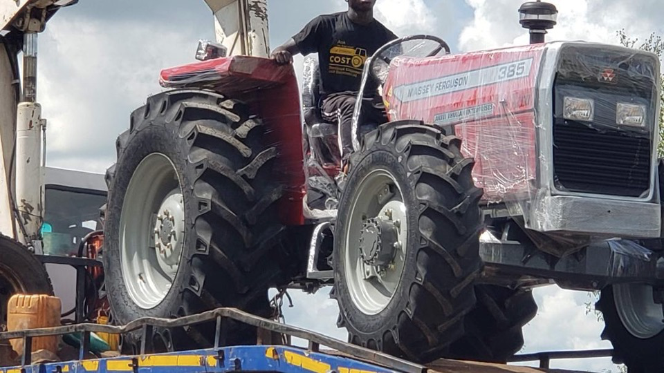 Wrapped MF tractor on a transport vehicle
